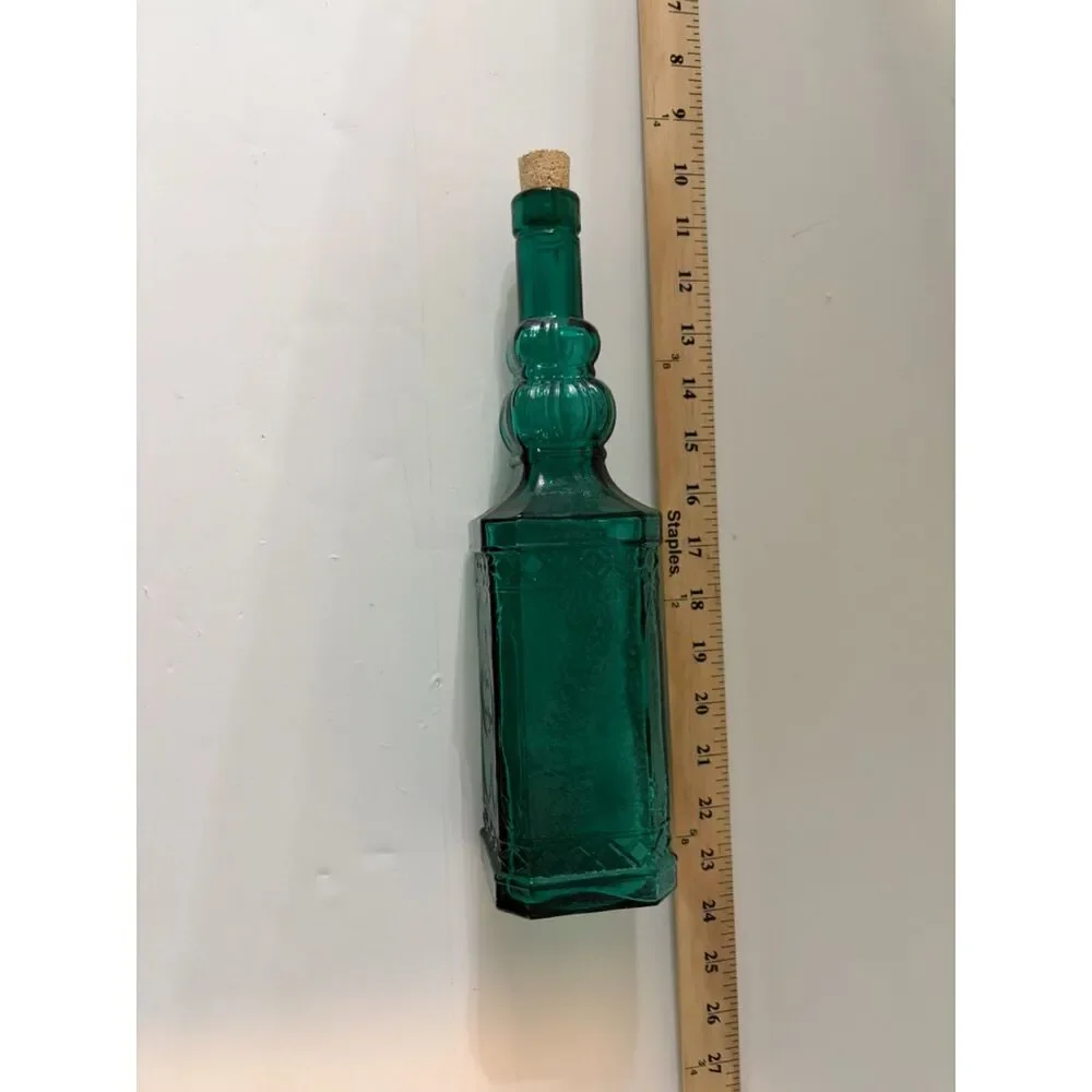 vtg emerald green glass decanter bottle with embossed sides and cork stopper